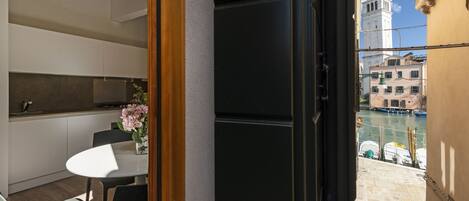A modern kitchen with white cabinets and a dining area with a table and chairs.