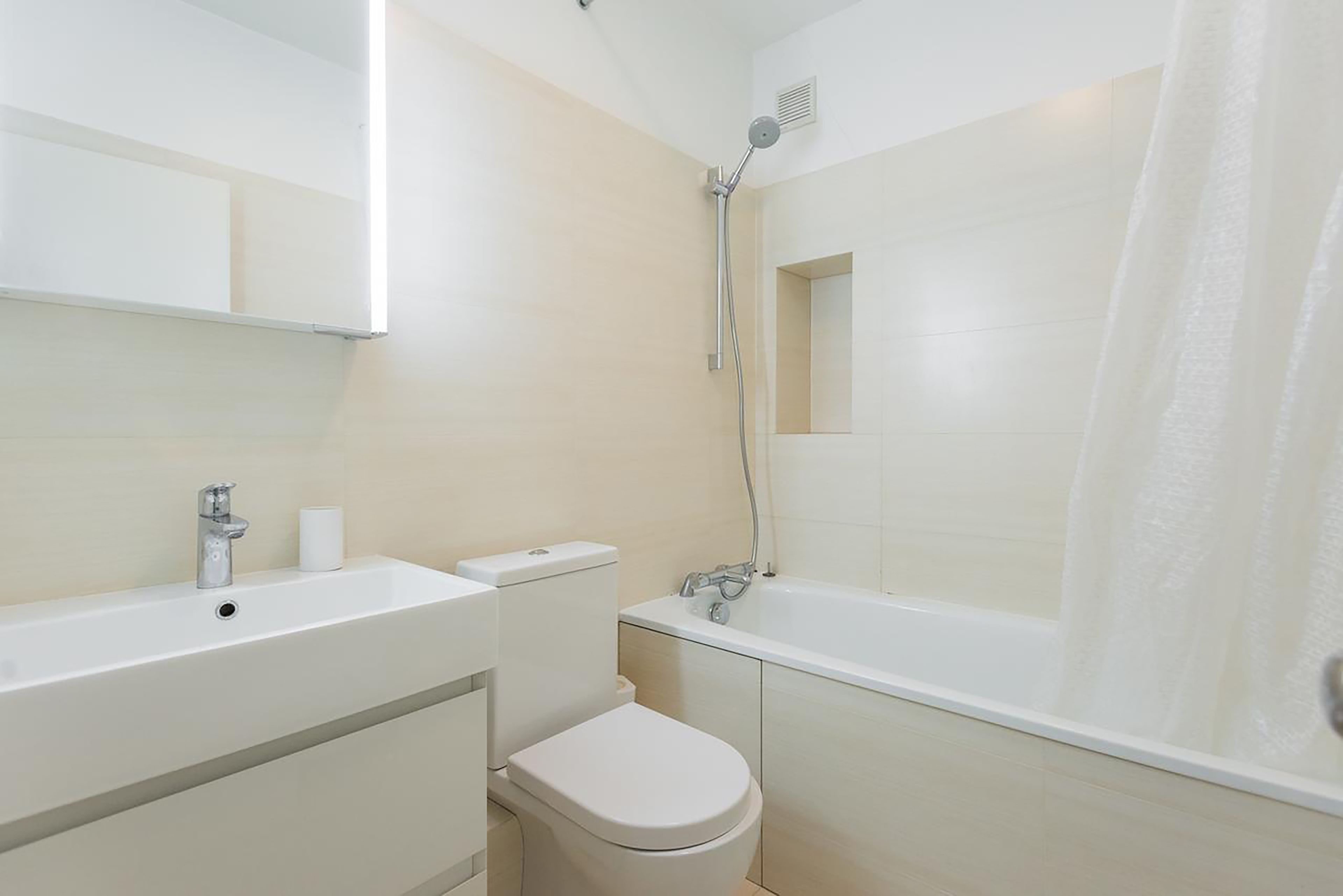 A bathroom with a sink, toilet, and bathtub.