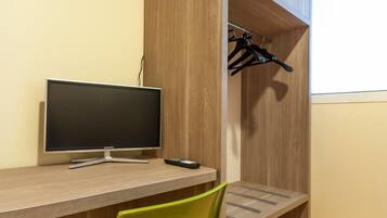 Desk, laptop workspace, iron/ironing board, cribs/infant beds