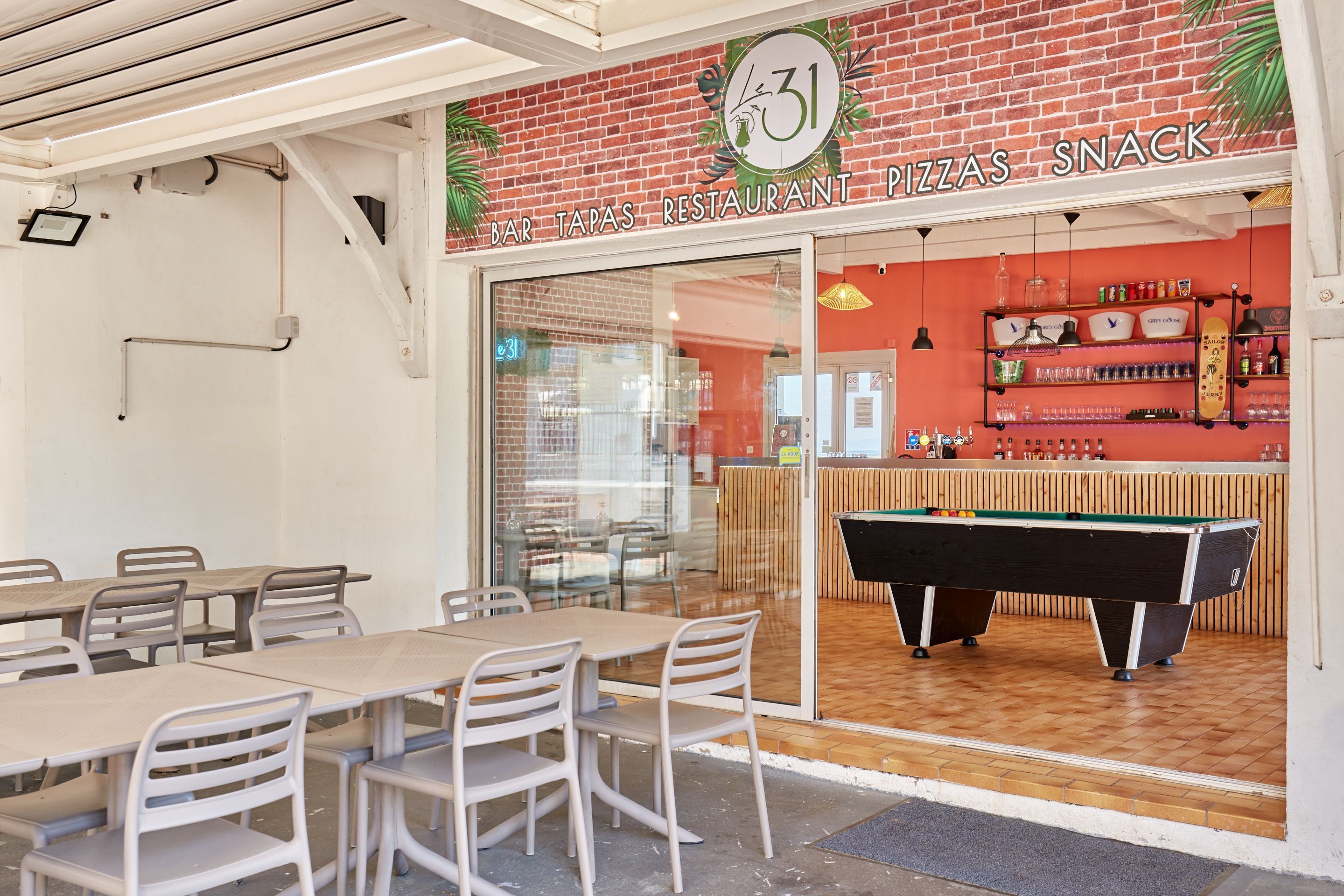 A bar and tapas restaurant with a pool table and seating area.