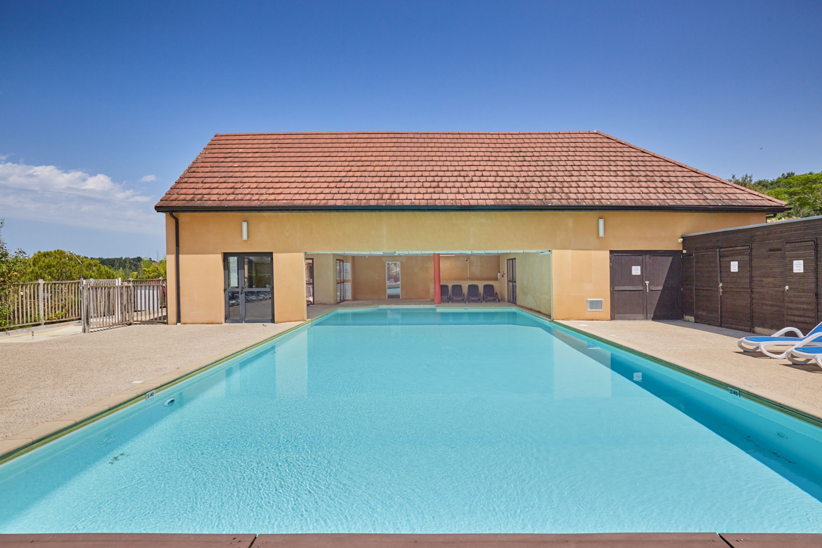 A swimming pool with a building in the background.