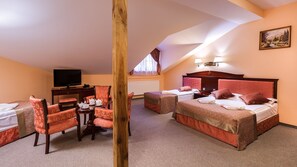 A hotel room with two beds, a desk, a television, and a painting on the wall. - Hotel Adam & Spa (Kudowa Zdroj)