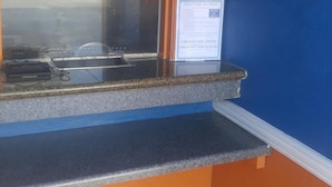 A check-in counter with a 'Partner Hotel' sign, an American flag, and a 'WiFi Available Here' sign. - Travel Eagle Inn Motel (Long Beach)