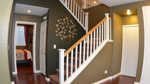 A staircase with white railings and wooden steps leading to a second floor. - Best Kept Secret! 4 King Beds ·Hot Tub · 9ft Pool Table · 5 Min to South Point (Las Vegas)
