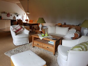 Relax in a warm and inviting space with a comfortable seating area and dining table.