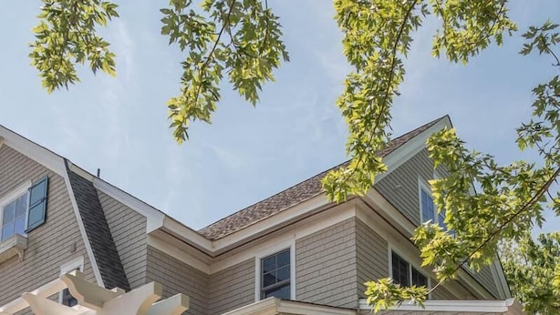 A two-story house with a covered porch, a brick exterior, and a number '608' on the front. - CORNER BEACH HOUSE (Cape May)