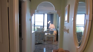 A hallway with a wooden bench, a mirror, and a window with curtains. - Magnificent Ocean Front. Beautiful five-star. Perfect, quiet get-away. (Bethany Beach)