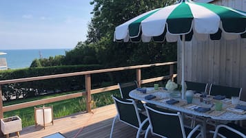 Enjoy meals on the deck overlooking a serene landscape and body of water.