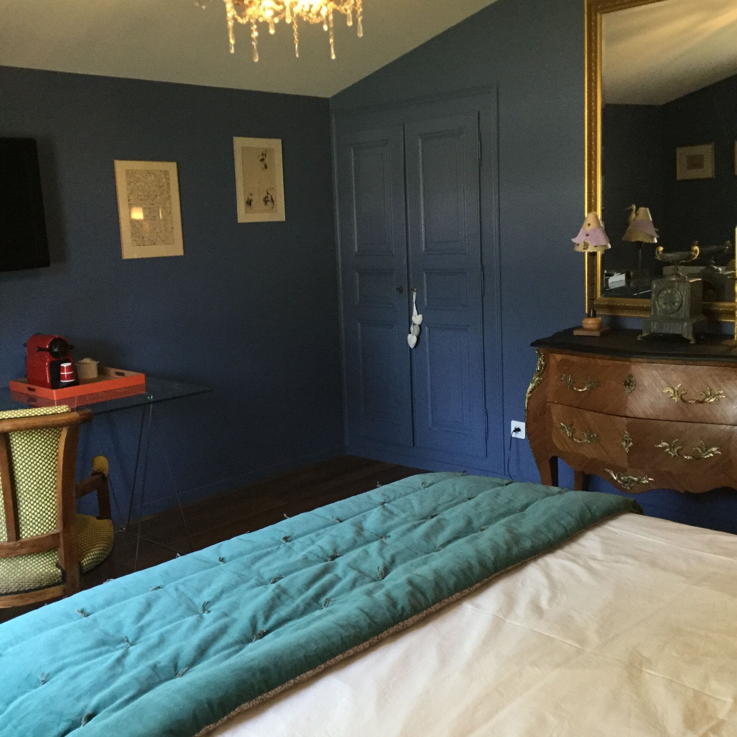 Un dormitorio con cama, cómoda y espejo.