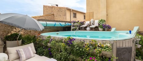 Seasonal outdoor pool, a rooftop pool, pool umbrellas, pool loungers