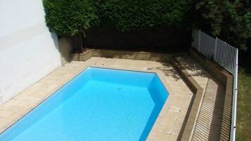 Seasonal outdoor pool, open 10:00 AM to 6:00 PM, pool umbrellas