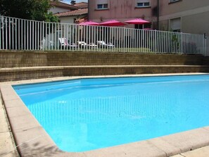 Seasonal outdoor pool, open 10:00 AM to 6:00 PM, pool umbrellas
