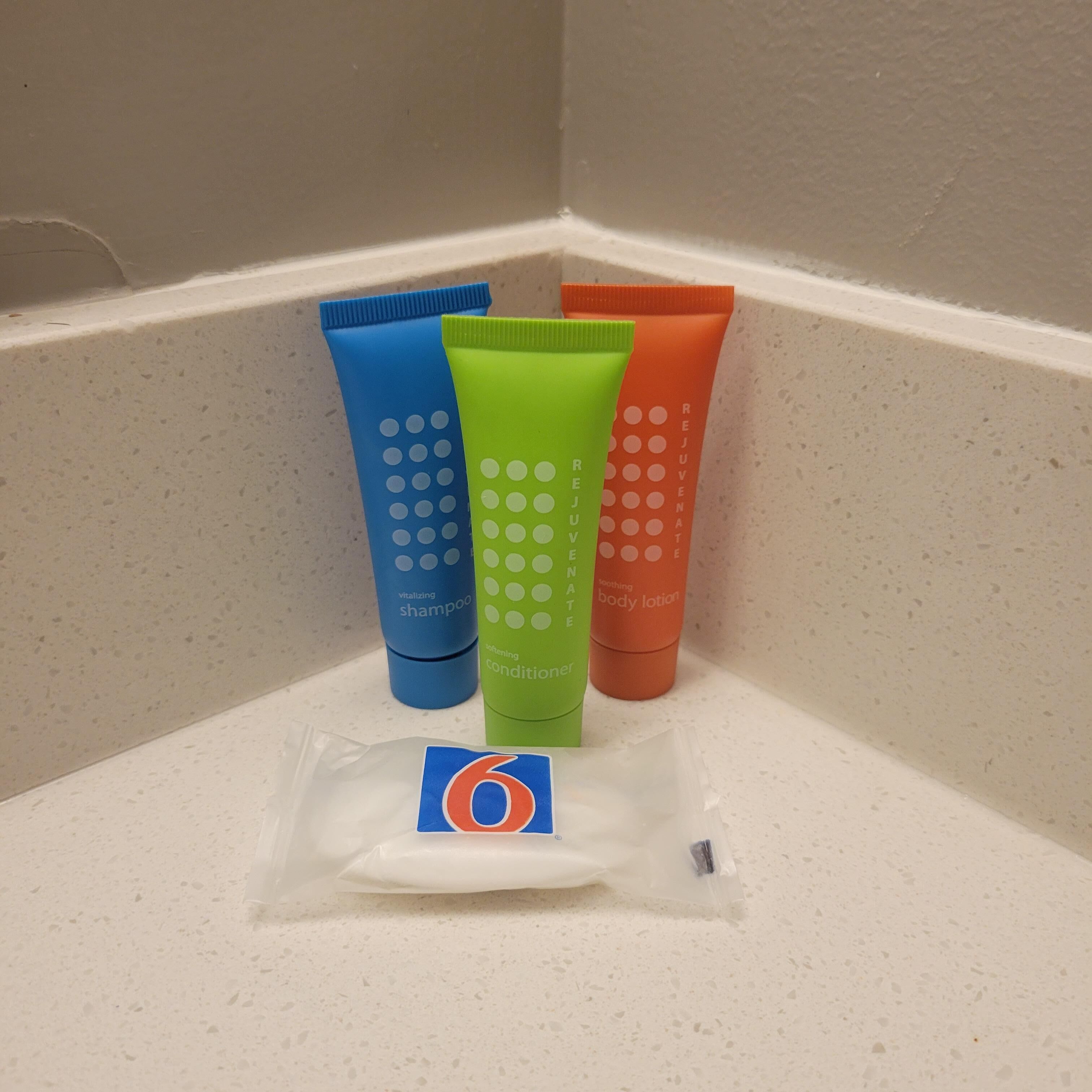 Three toiletry tubes on a countertop.