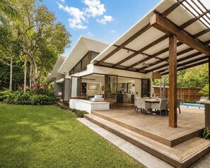A modern house with a wooden deck, outdoor seating, and a pool. - Luxe Beachfront Haven w/heated pool. Pet-Friendly (Broken Head)