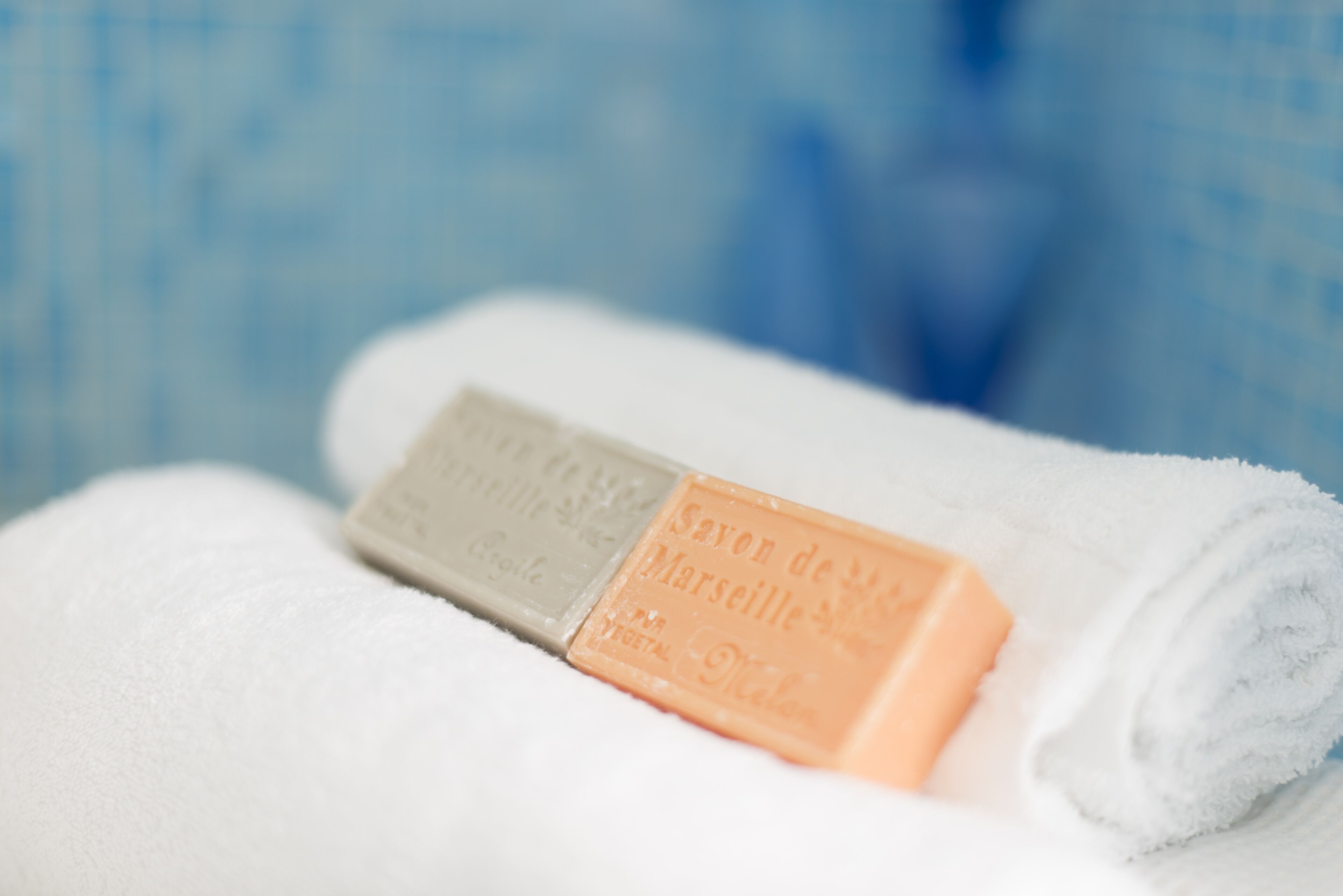 A white towel with two soap bars on it.