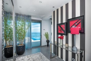 Enjoy a serene coastal retreat with a balcony offering views of the sky and water.