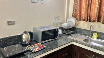Full-sized fridge, microwave, stovetop, electric kettle