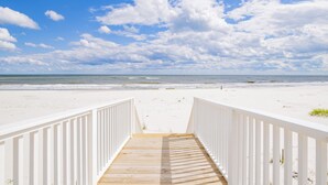 A wooden pathway leading to a beach with white railings, under a partly cloudy sky. - "The Pearl" GULF FRONT w/prvt heated pool, 12 bdrm /12.5bath "ALVacationRentals" (Gulf Shores)