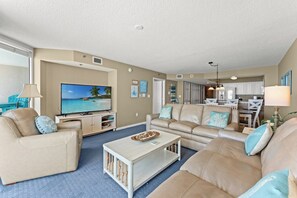 A living room with a television, sofas, and a coffee table. - Cozy and Bright Condo with Jacuzzi Tub, Lazy River | Crescent Shores - S 1211 (North Myrtle Beach)