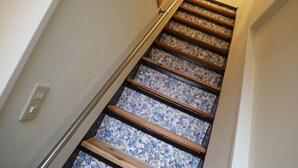 A staircase with wooden steps and blue floral patterned risers. - Bar & Hostel MONDO - Hostel (Osaka)