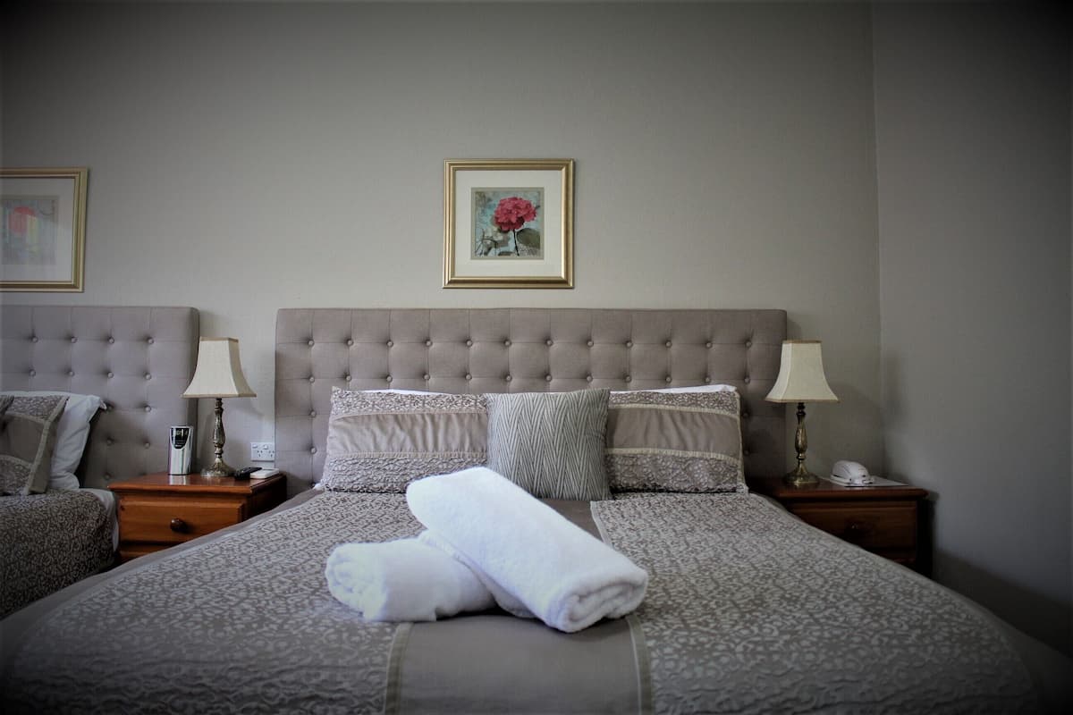 Escritorio, cortinas blackout y tabla de planchar con plancha