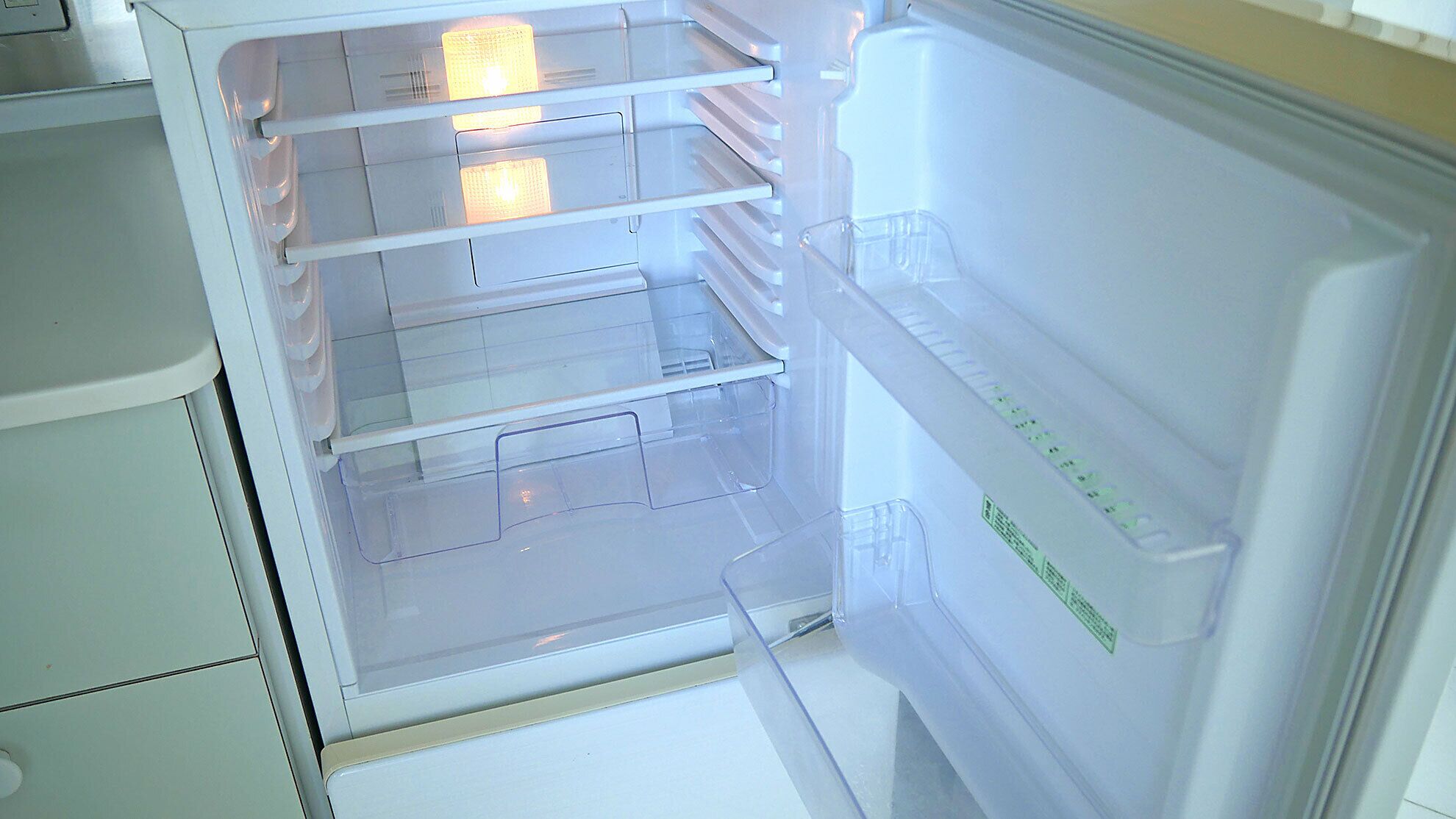 An open refrigerator with multiple shelves and a freezer compartment.