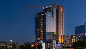 A high-rise hotel with a prominent 'L HOTEL' sign at the top. - L Hotel Changsheng (Zhuhai)