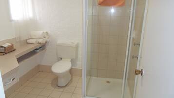 A bathroom with a toilet, sink, and shower.
