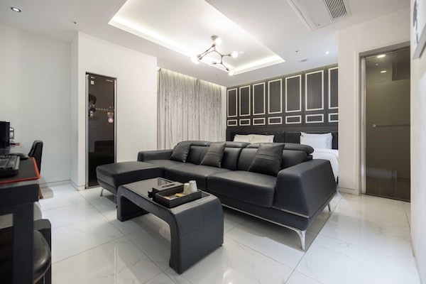 Suite | Premium bedding, desk, laptop workspace, blackout drapes