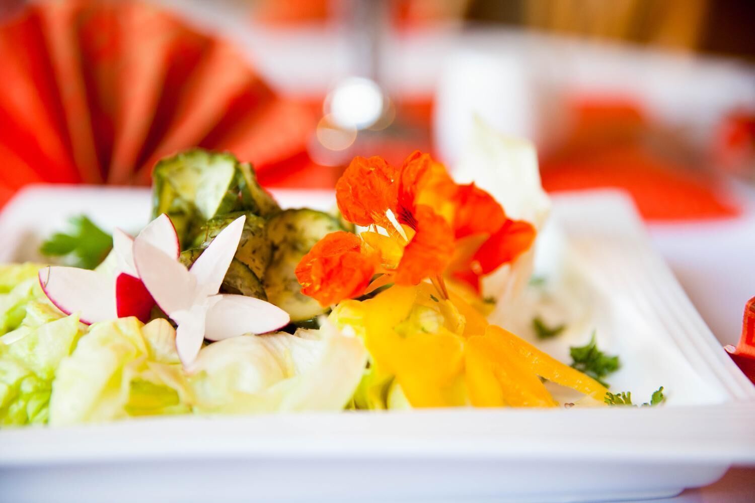 A plate of colorful vegetables and flowers.