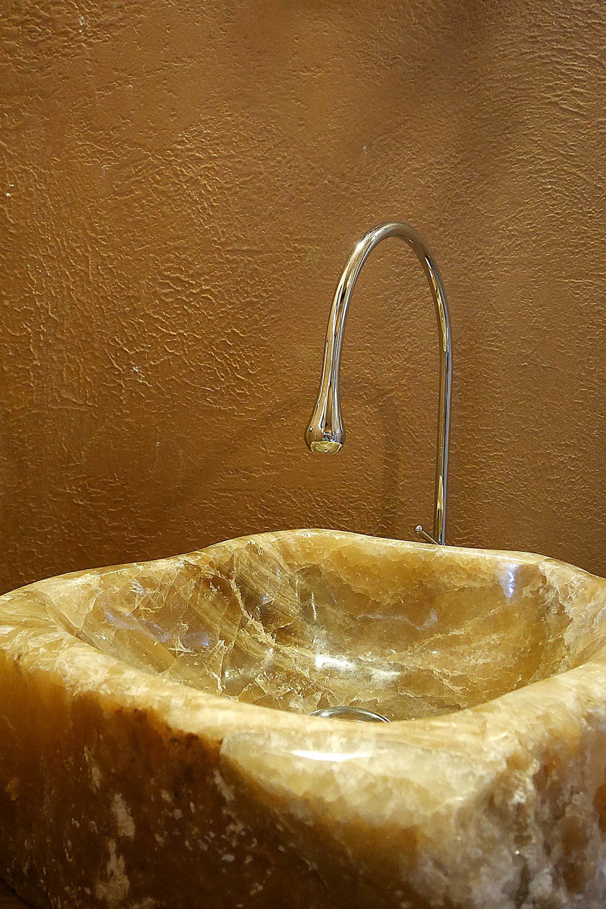 A marble sink with a single faucet.