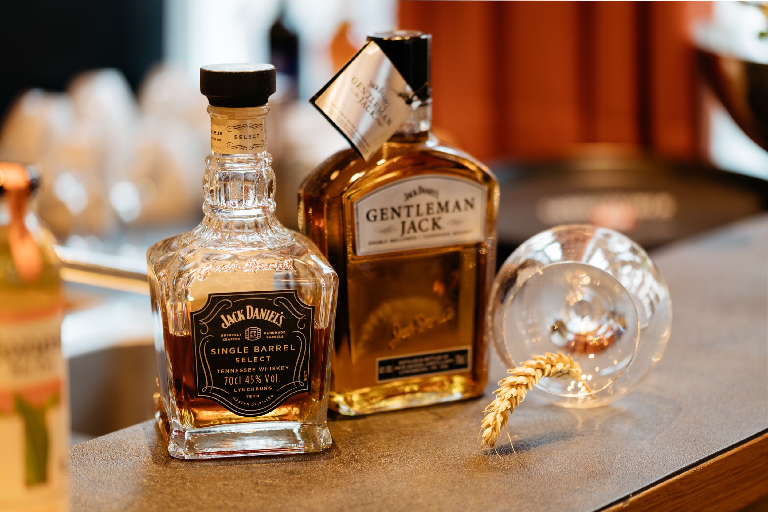 Three bottles of whiskey on a bar counter.