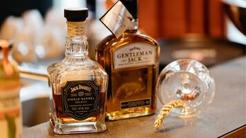 Three bottles of whiskey on a bar counter.