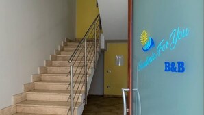 A staircase with a metal railing leading to a landing. - B&B Sardinia For You (Oristano)