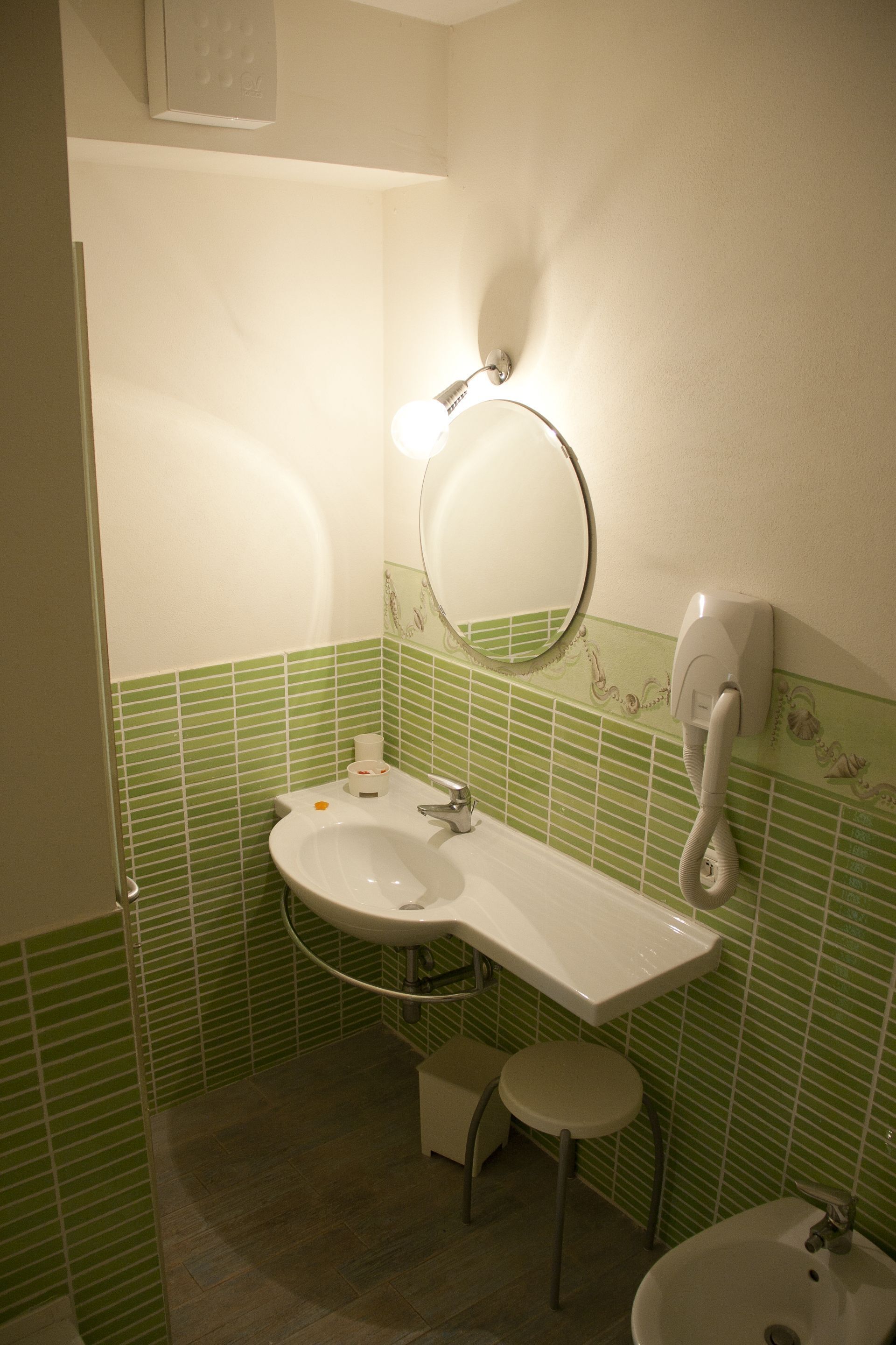 A bathroom with a sink, mirror, and toilet.