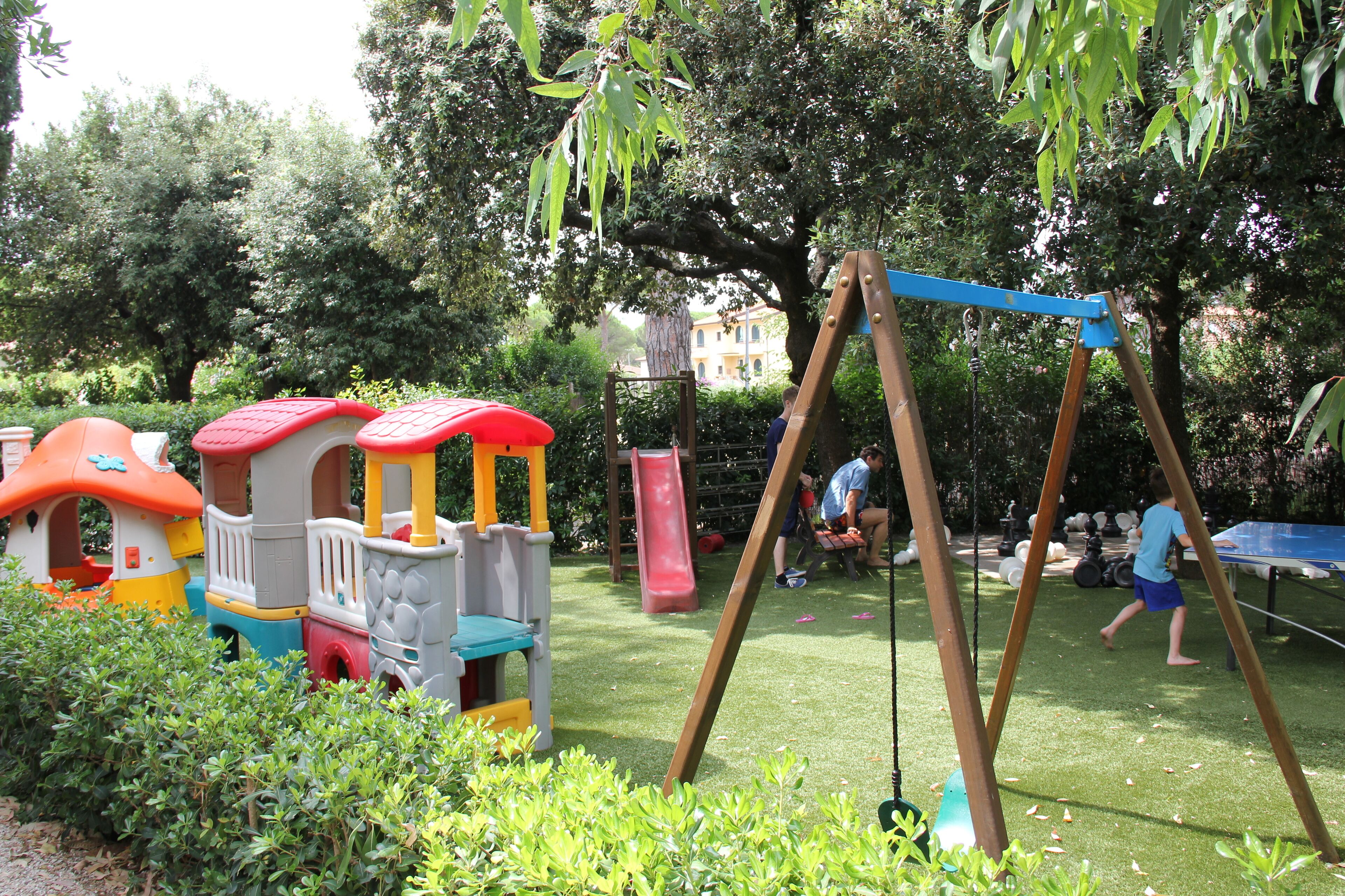 A playground with a slide, swings, and a climbing structure.