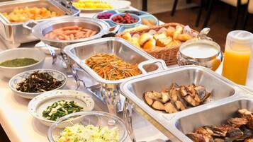 A buffet with various food options including meats, vegetables, and salads.
