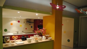 A modern kitchen with a central island, a sink, and various kitchen appliances.