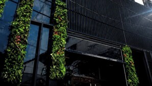 A modern building with a checkered facade, large windows, and vertical greenery. - The Sargon (Ho Chi Minh City)