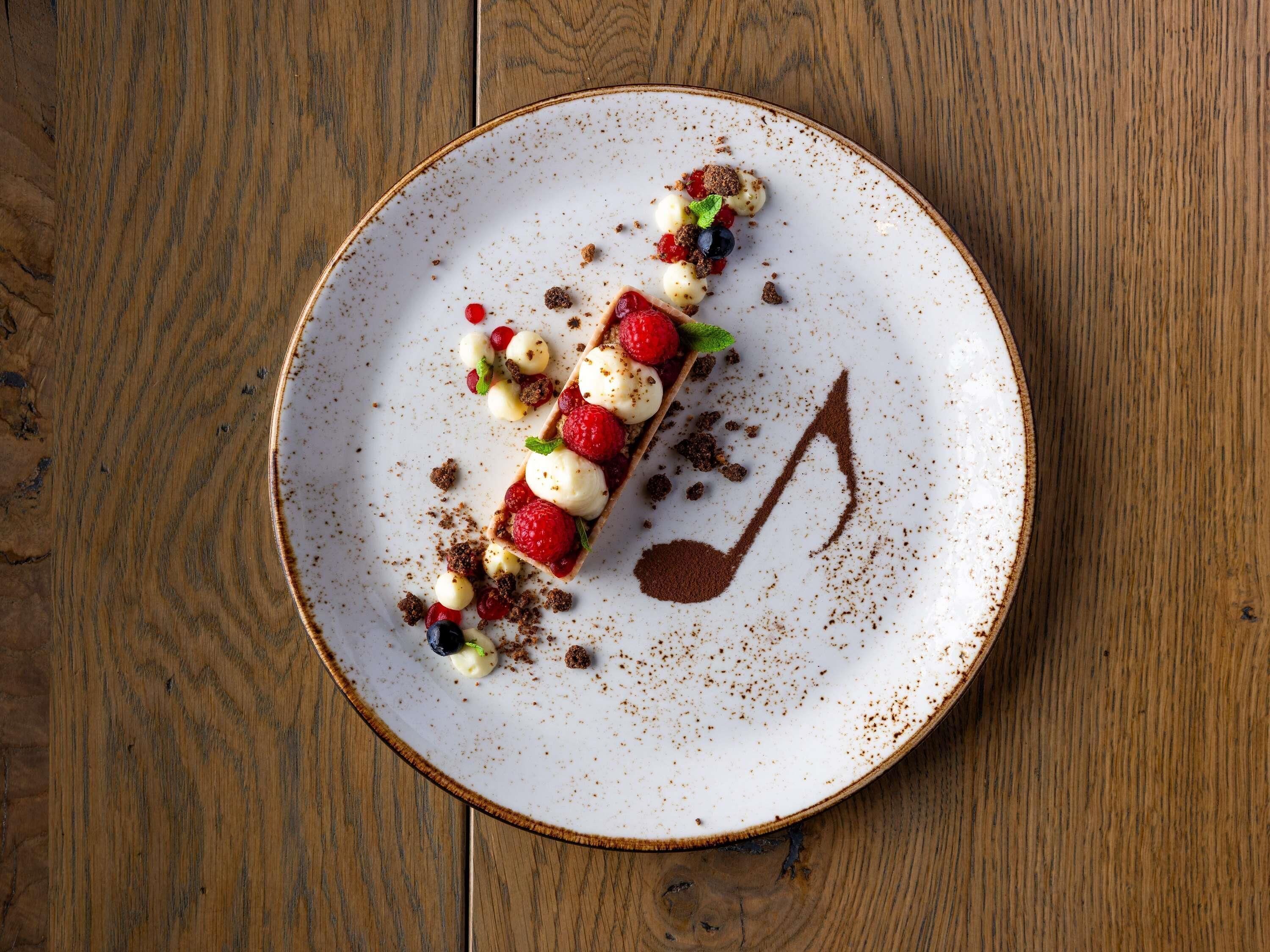 A dessert on a plate with a musical note design.