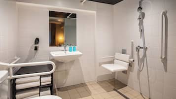 A modern bathroom with a toilet, sink, and shower.