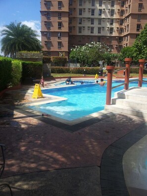 Outdoor pool, open 9:00 AM to 3:00 PM, pool umbrellas - Avida Tower Sucat (Parañaque)