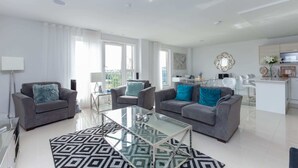 A modern living room with two grey sofas, a glass coffee table, and a patterned rug. - Luxurious Central Edinburgh Apartment - Sleeps 6 (Edinburgh)