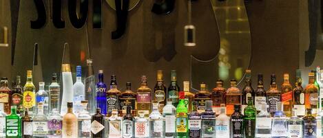 A bar with a variety of liquor bottles displayed on the counter.
