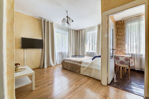 Relax in a stylish room with a comfortable bed, flat-screen TV, and a cozy dining area.