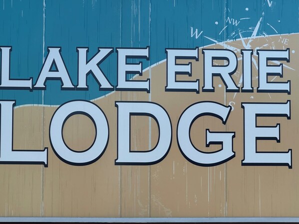 A sign for Lake Erie Lodge with large, bold lettering.