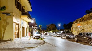 A street lined with parked cars and buildings with balconies. - Deluxe Suites (Chania)