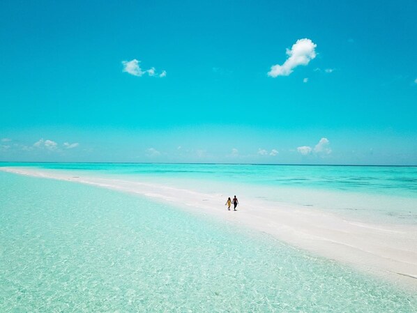 Beach nearby, white sand, beach umbrellas, beach towels