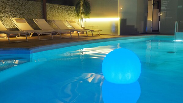 Indoor pool, pool umbrellas, pool loungers