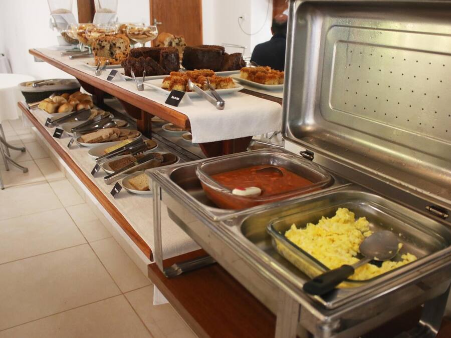 A buffet with various food items including baked goods, casseroles, and scrambled eggs.